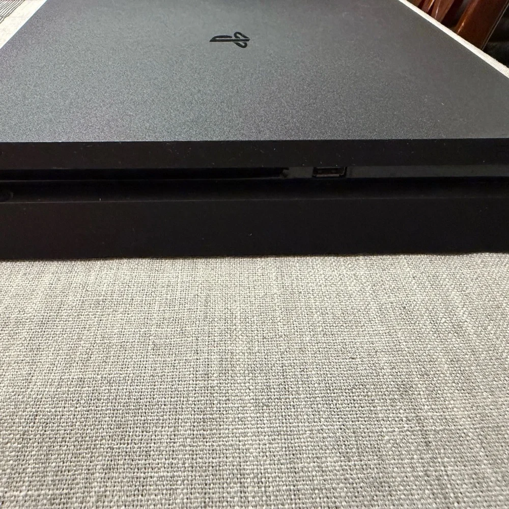 Sony PlayStation 4 (PS4) with controllers